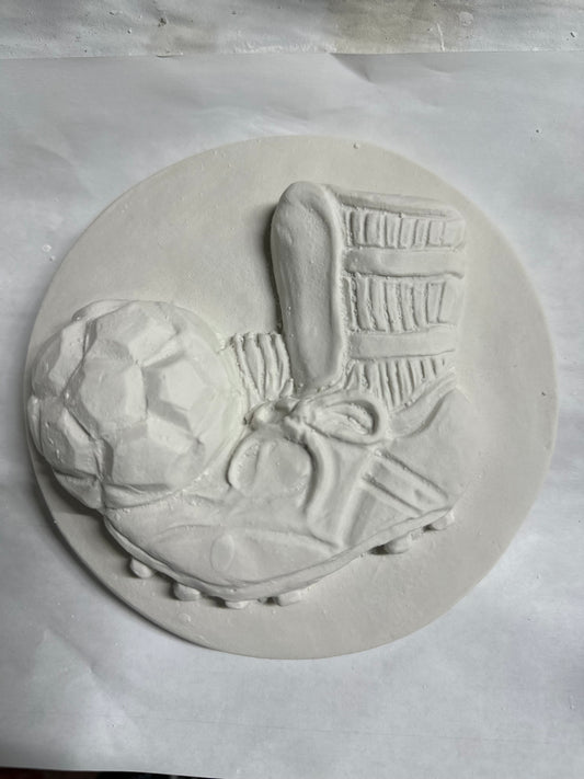 Soccer cleat and ball